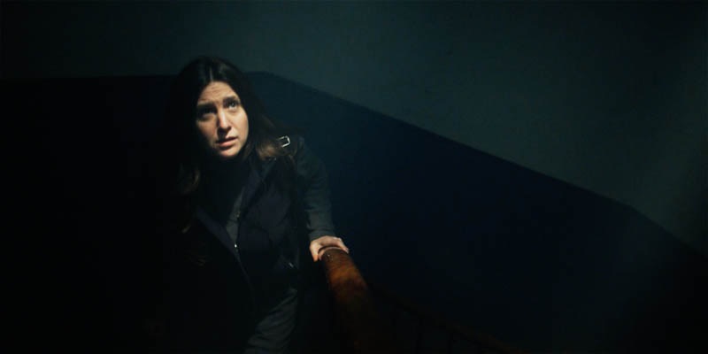 Karen looks towards the top of the stair